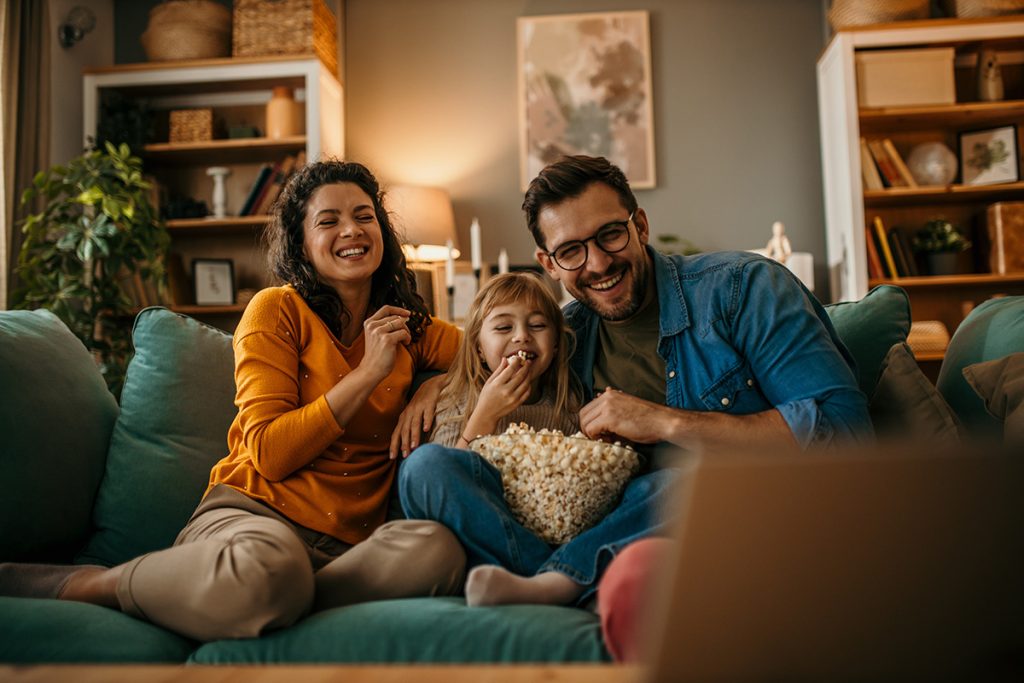 The joy of togetherness as a mom, dad, and daughter share a movi